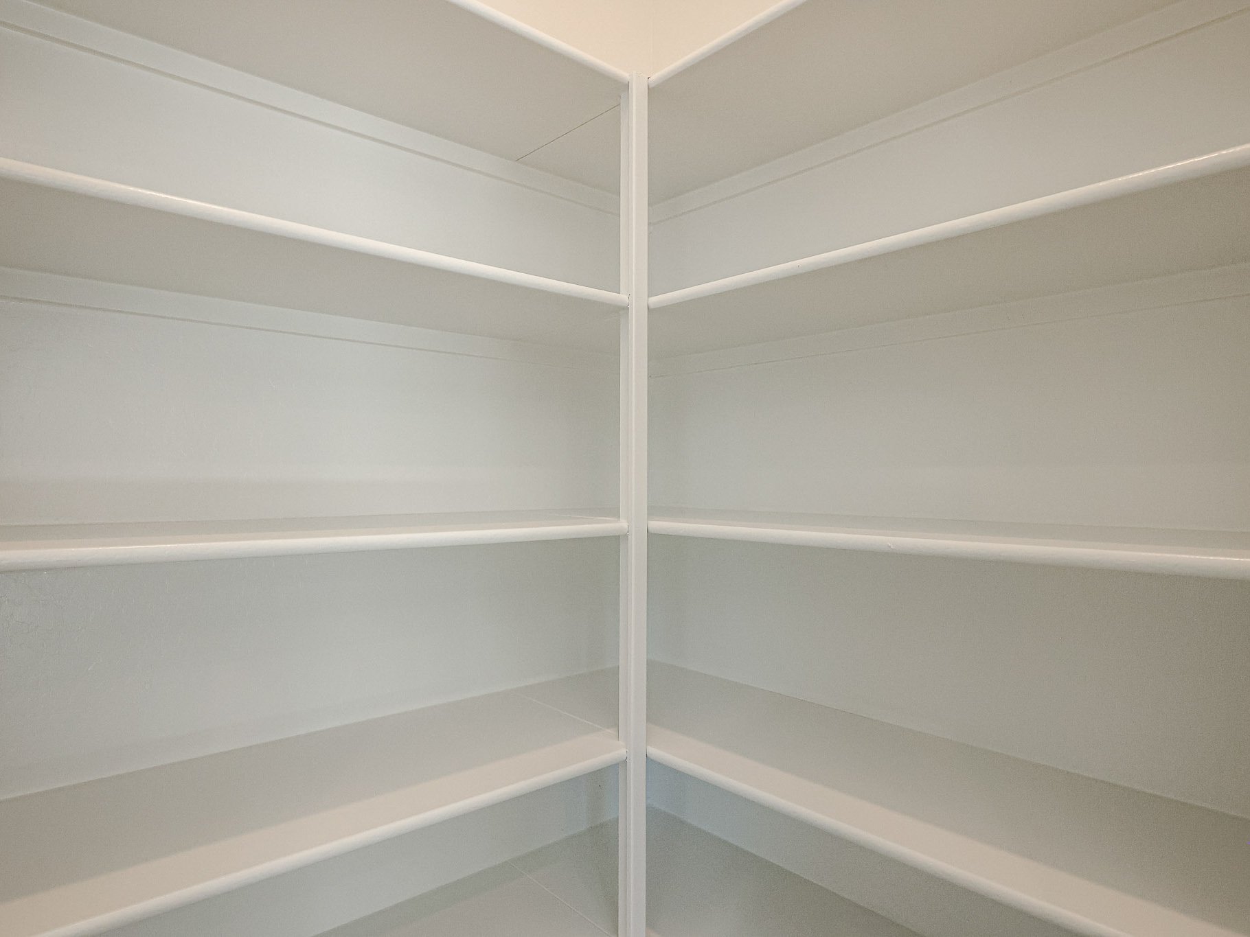 A white wall with a white railing.