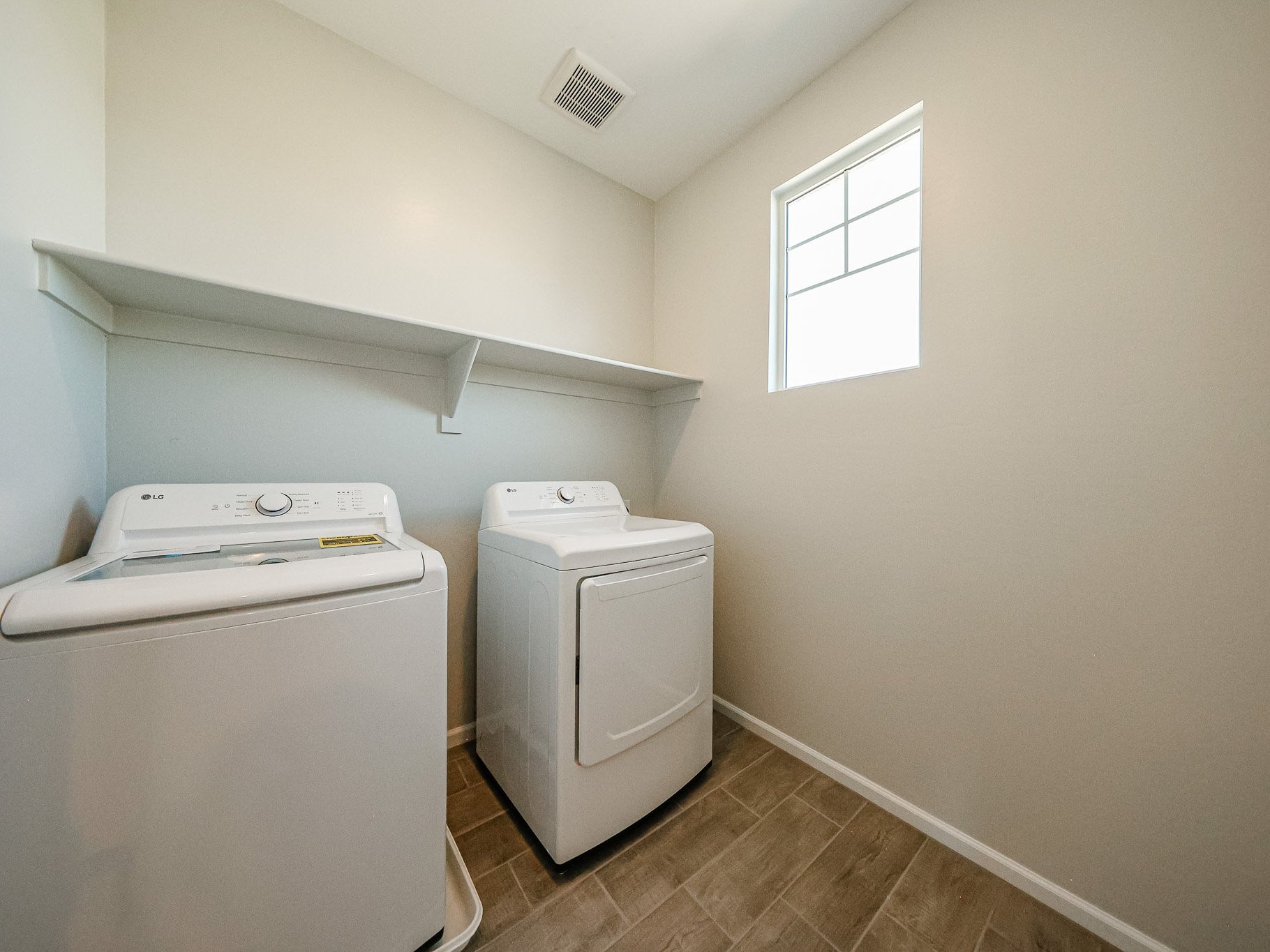 A laundry room with a washer and dryer.