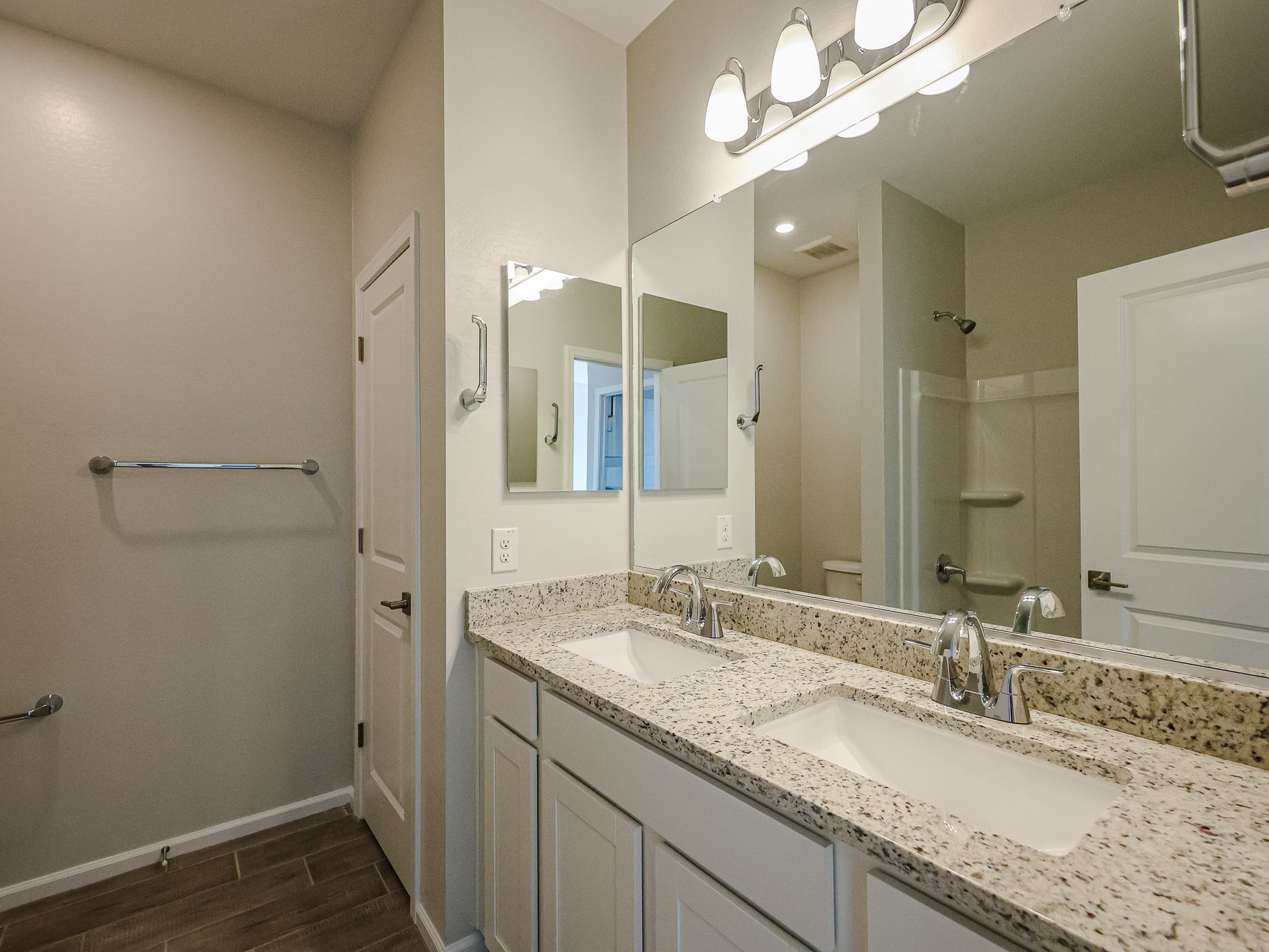 A bathroom with a large mirror.