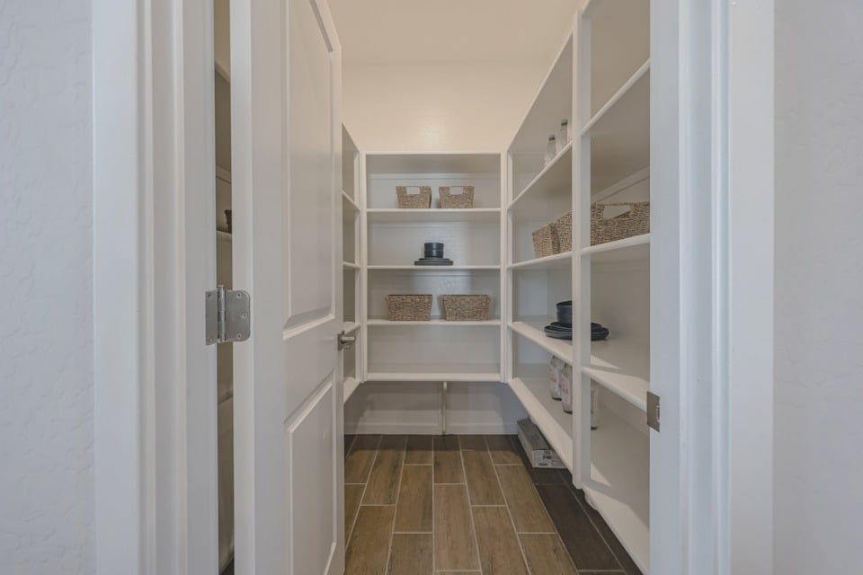 A white closet with shelves.