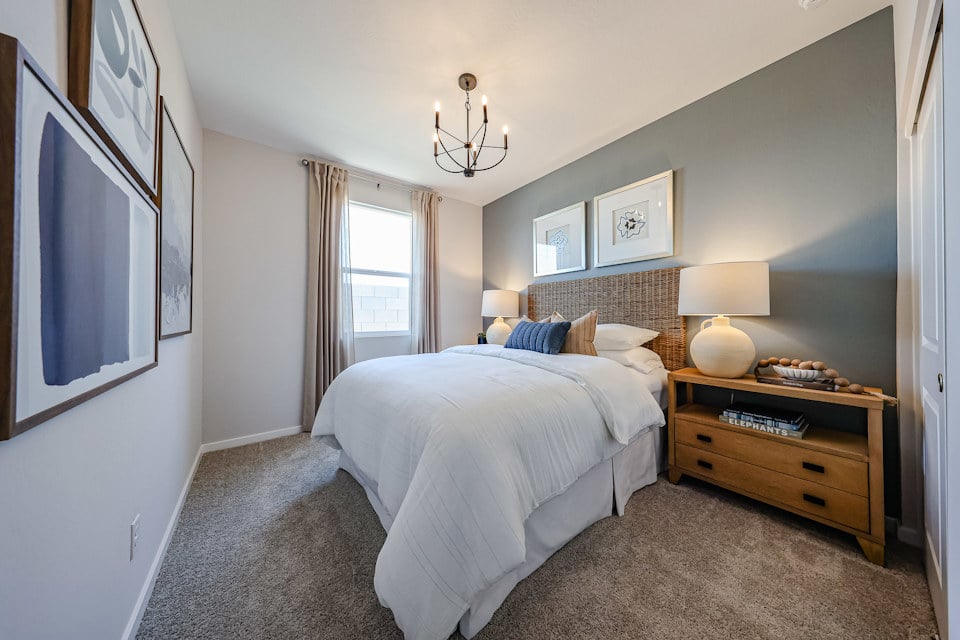 A bedroom with a bed and a dresser.