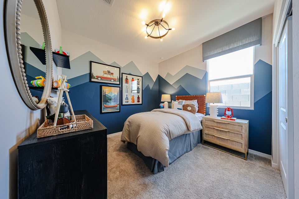 A bedroom with a bed and dresser.