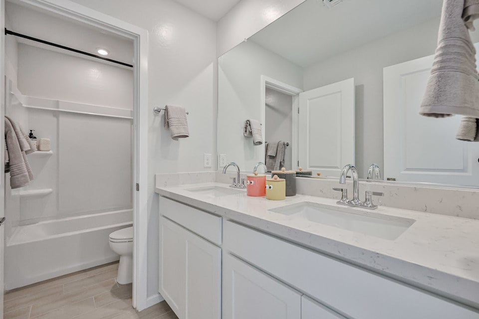 A bathroom with a tub sink and toilet.