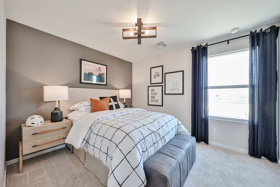 A bedroom with a bed and a desk.