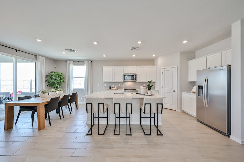 A kitchen with a table and chairs.