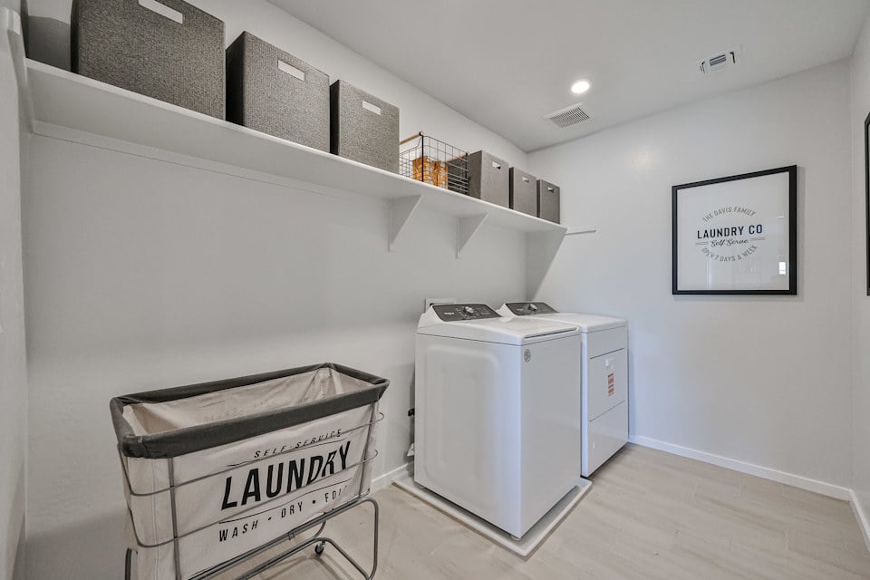 A room with a washer and dryer.