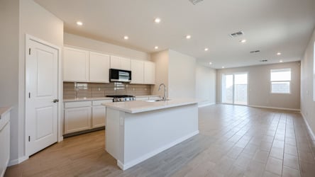 A kitchen with white cabinets.