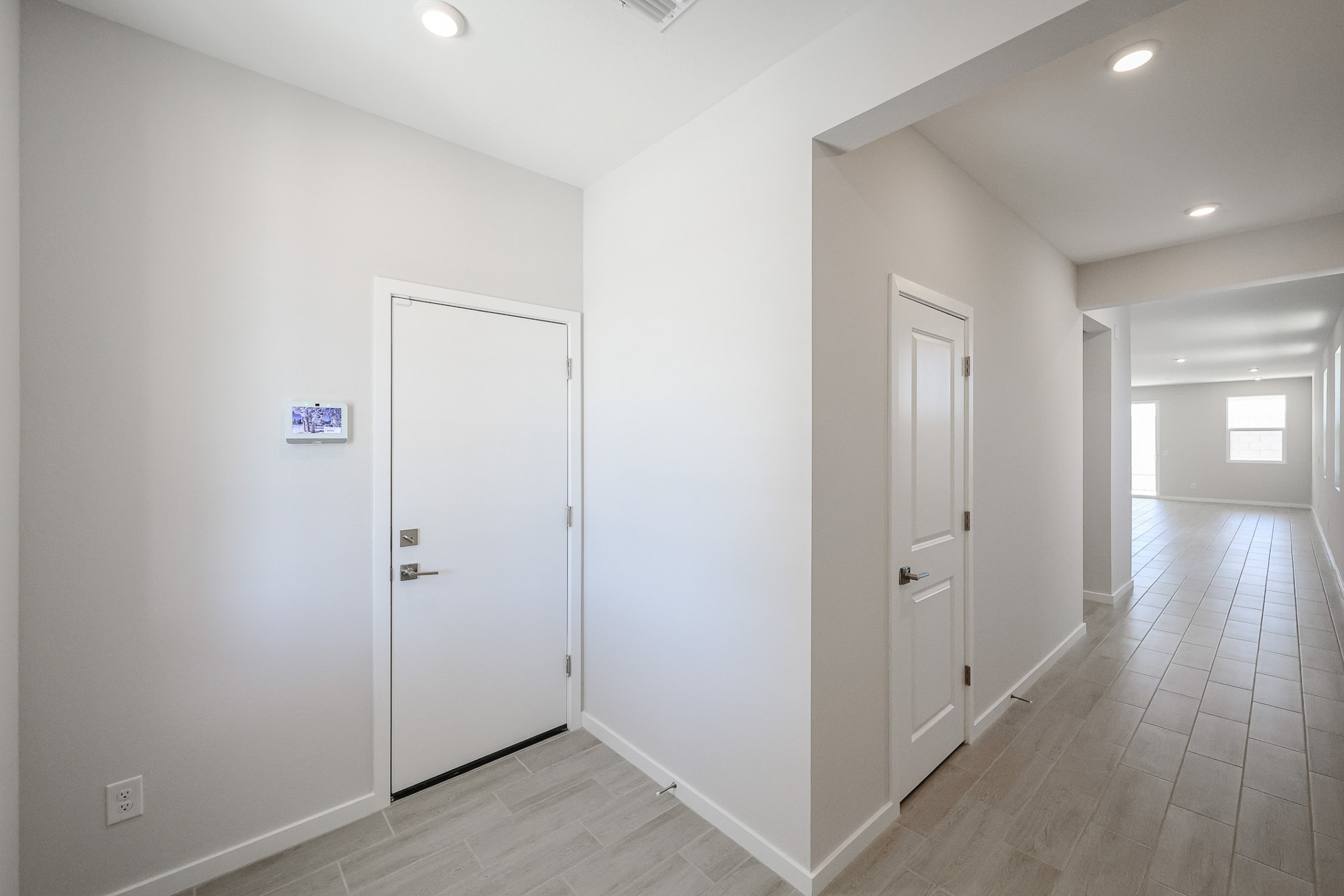 A hallway with white doors.