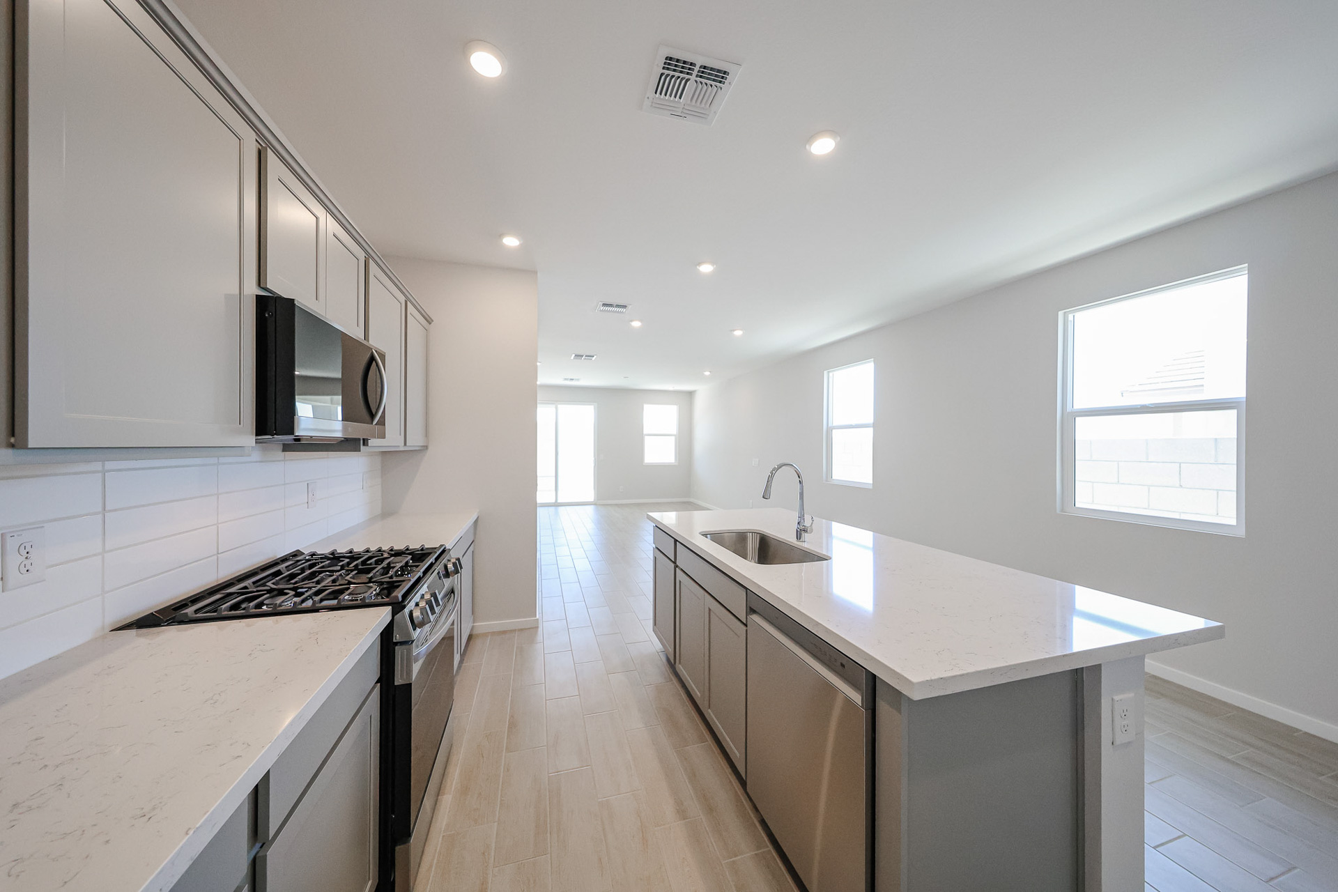 A kitchen with white cabinets.