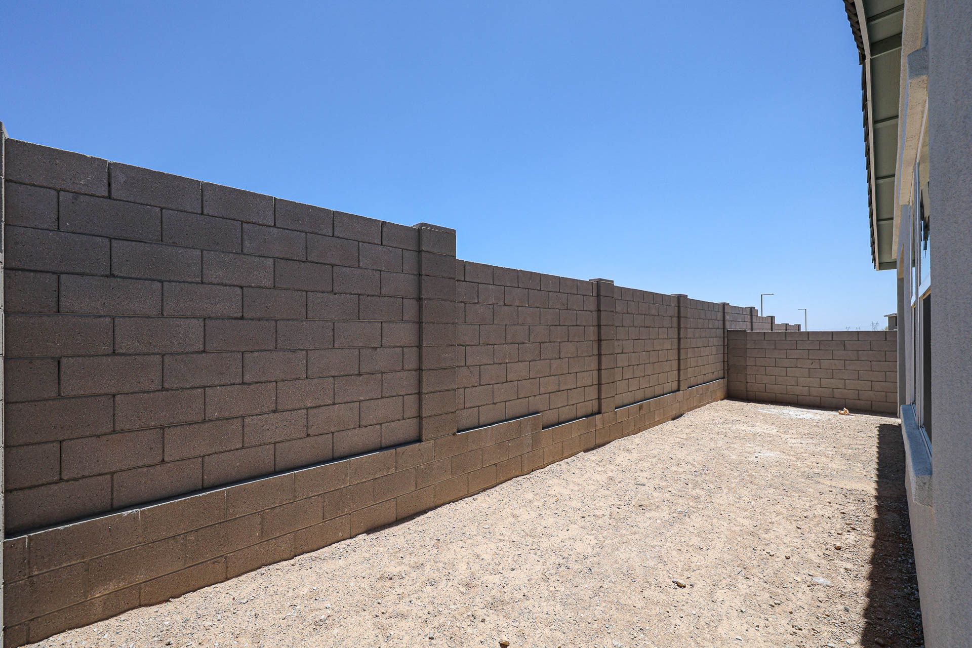 A brick wall with a blue sky.