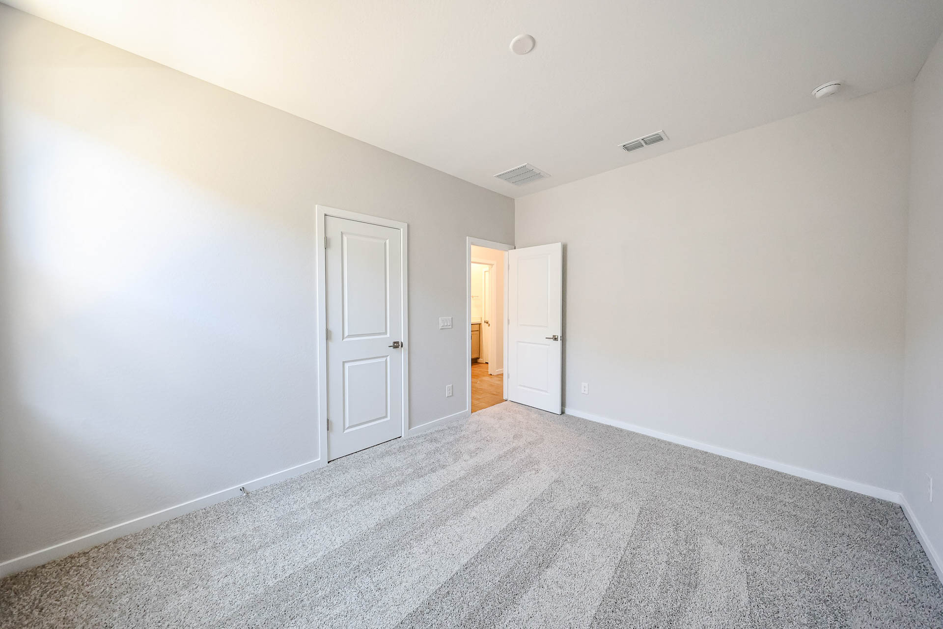 A hallway with white doors.