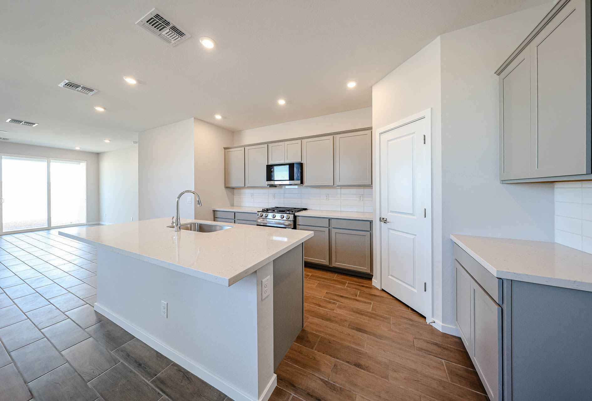 A kitchen with white cabinets.