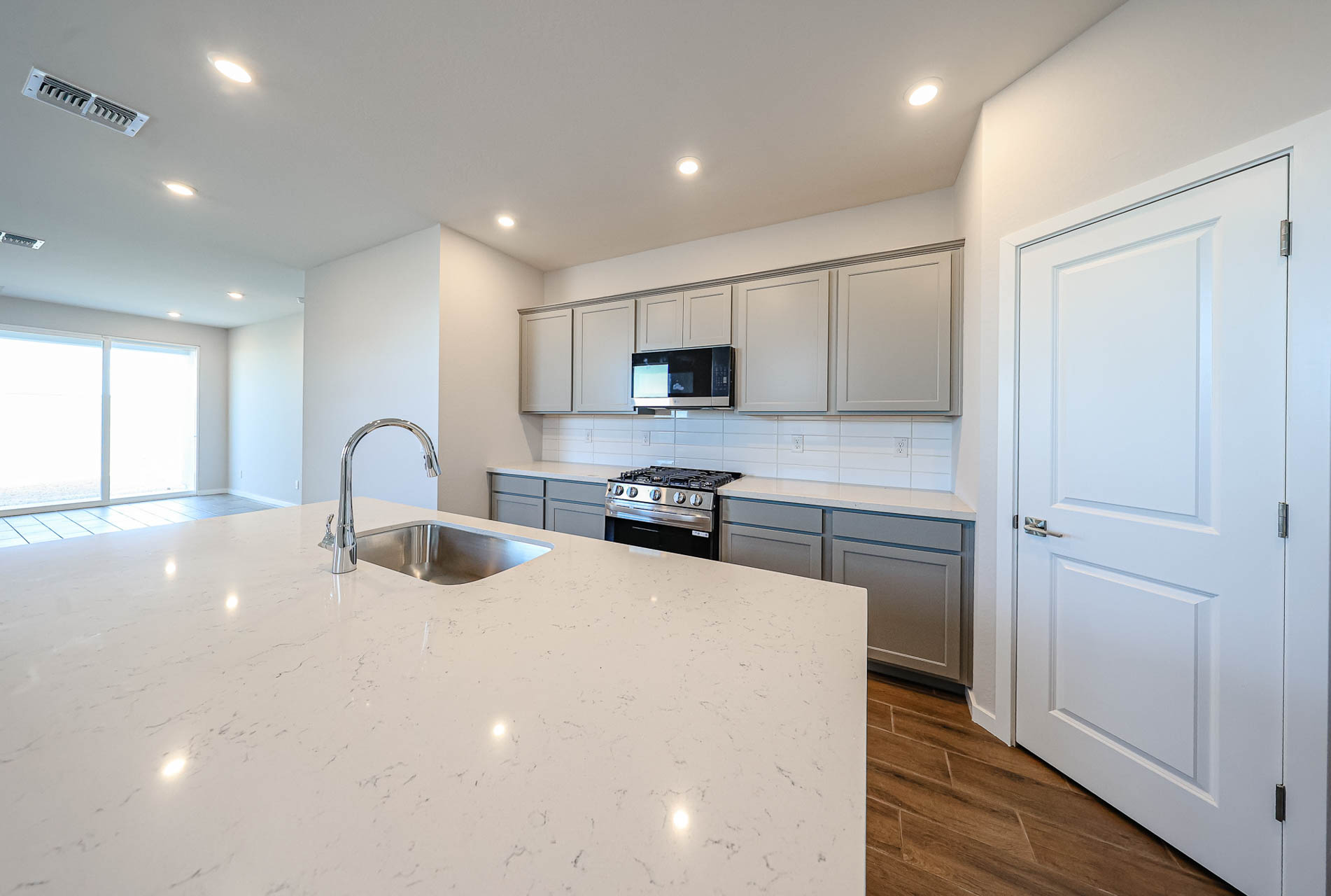 A kitchen with white cabinets.