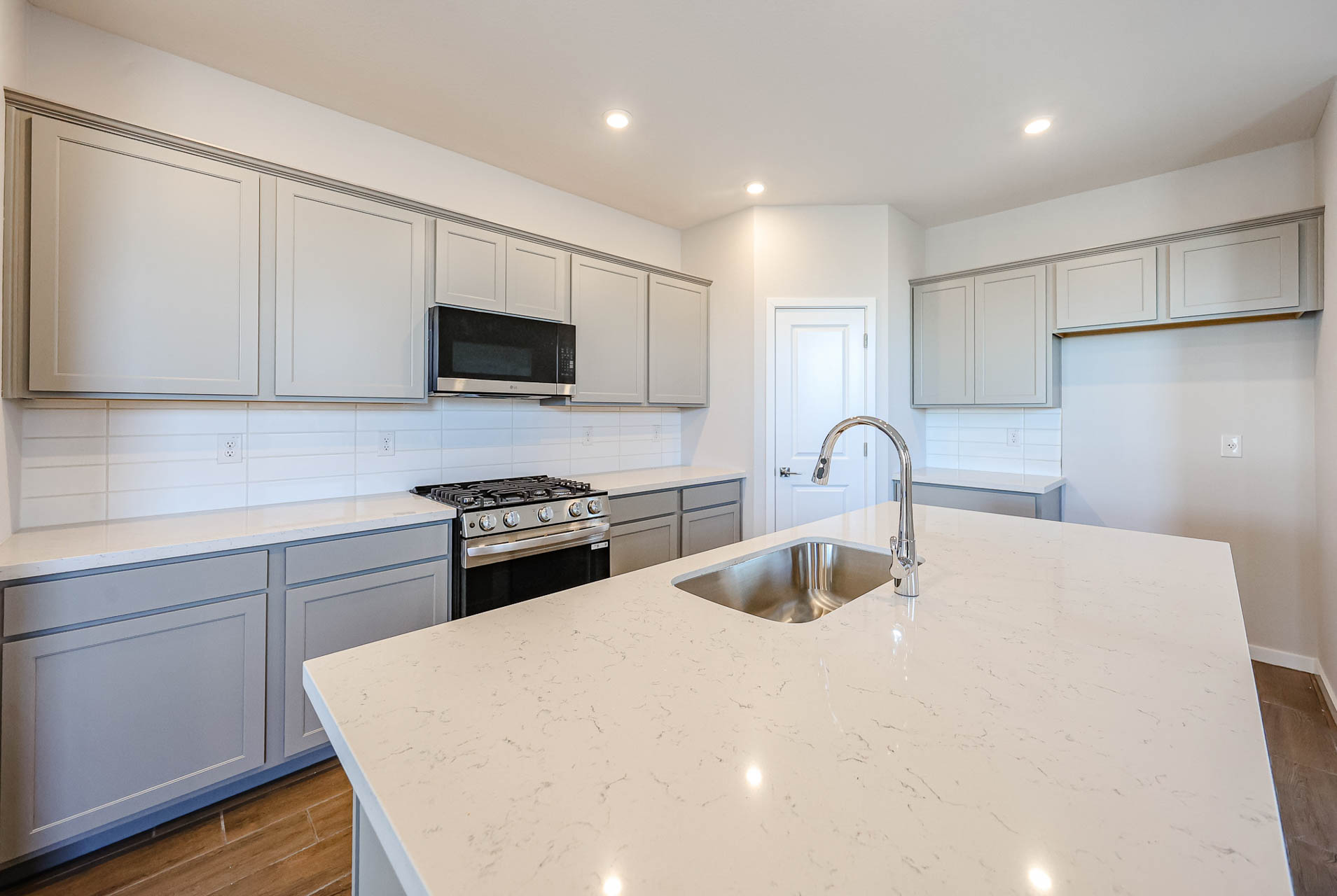 A kitchen with white cabinets.
