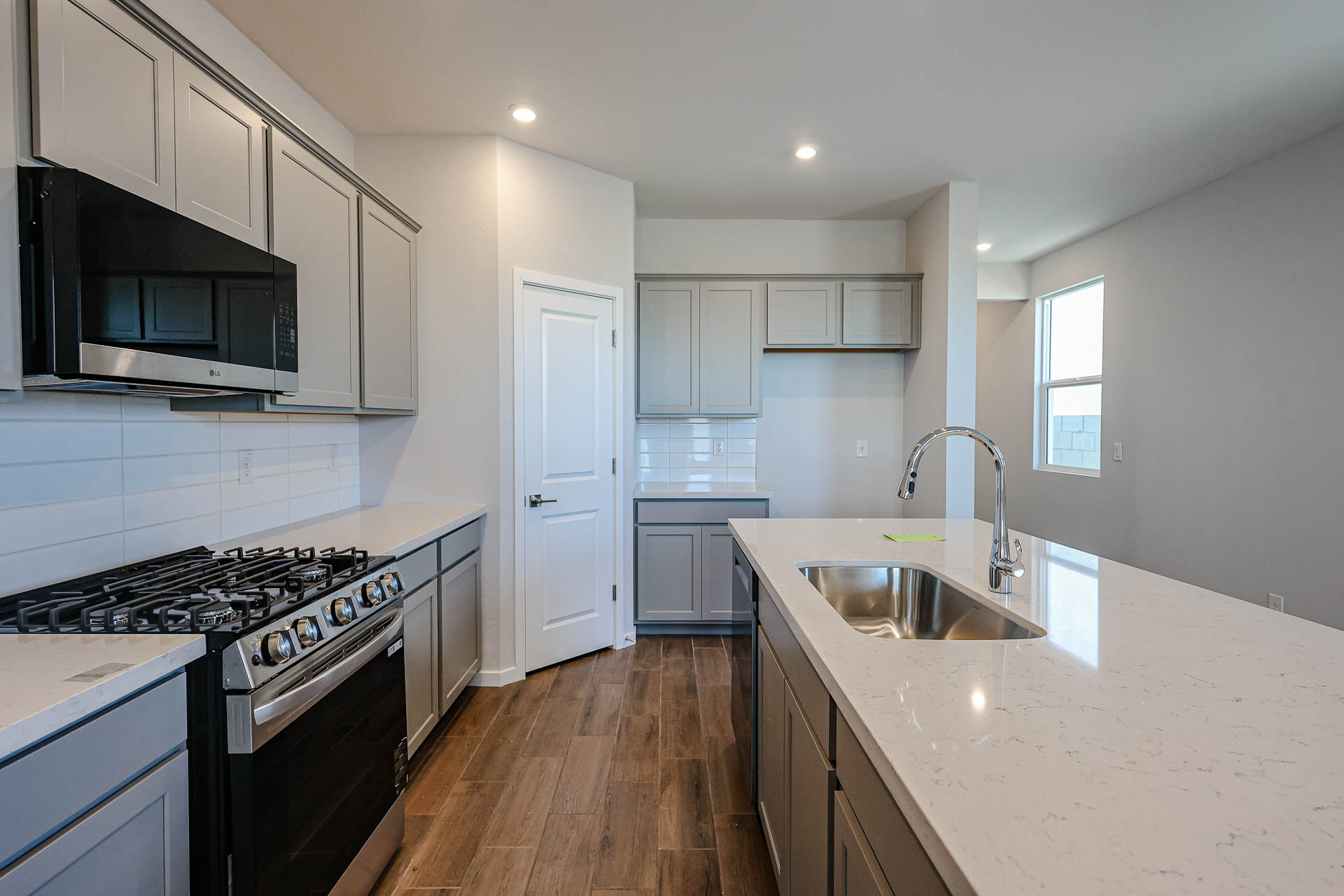 A kitchen with white cabinets.