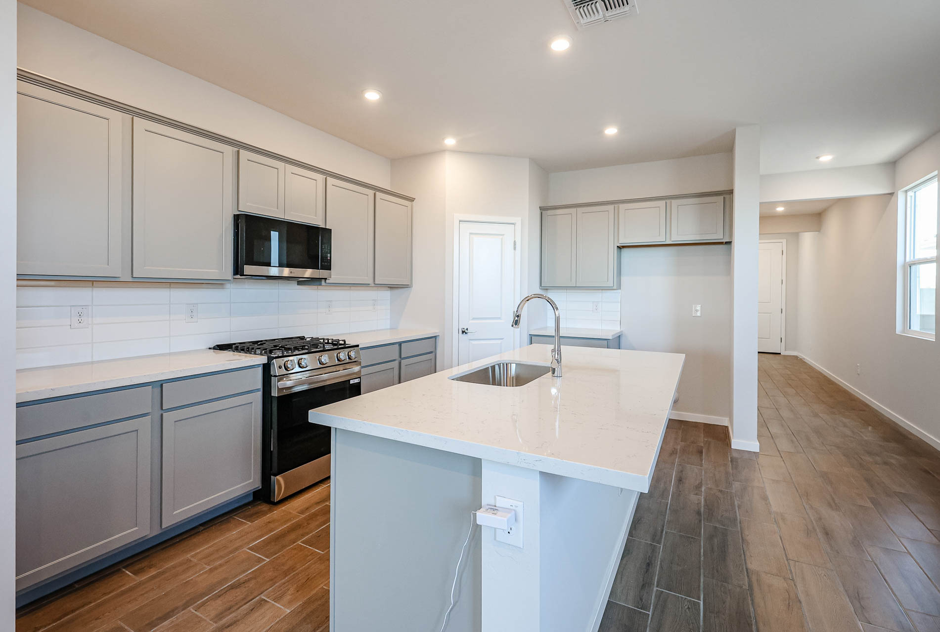 A kitchen with white cabinets.