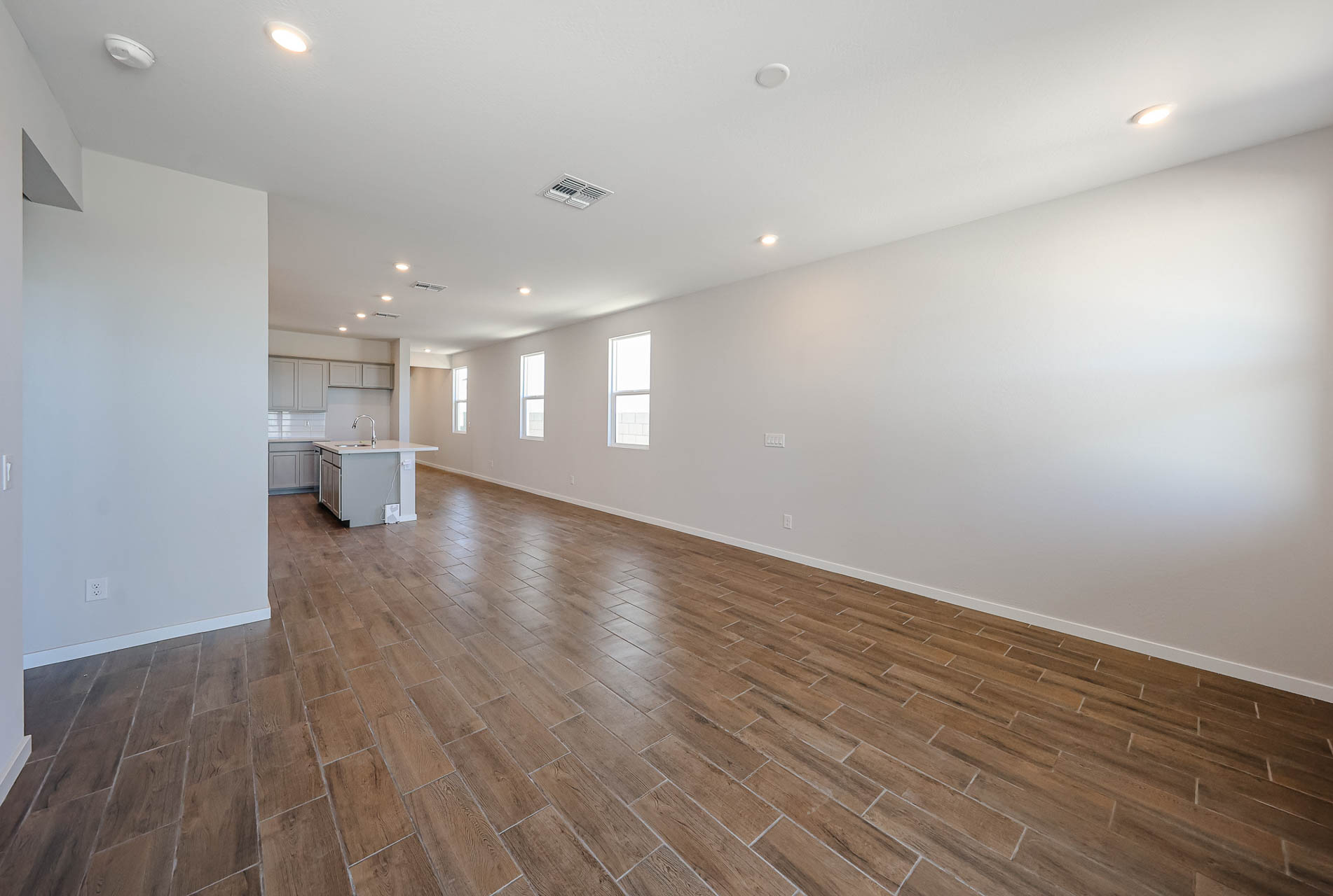 A room with a wood floor and white walls.
