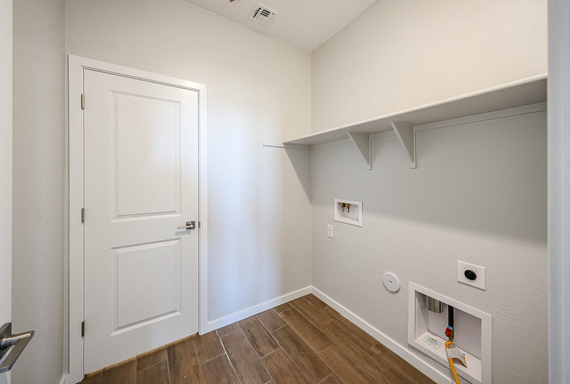 A room with white walls and a wood floor.