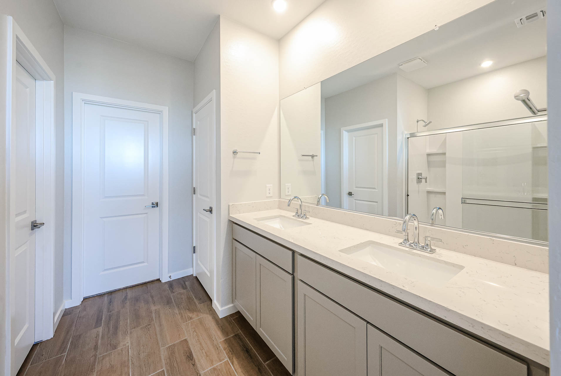 A bathroom with a large mirror.