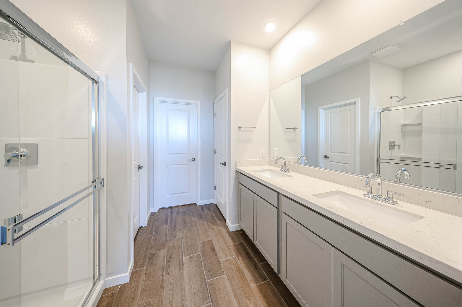 A bathroom with a large mirror.