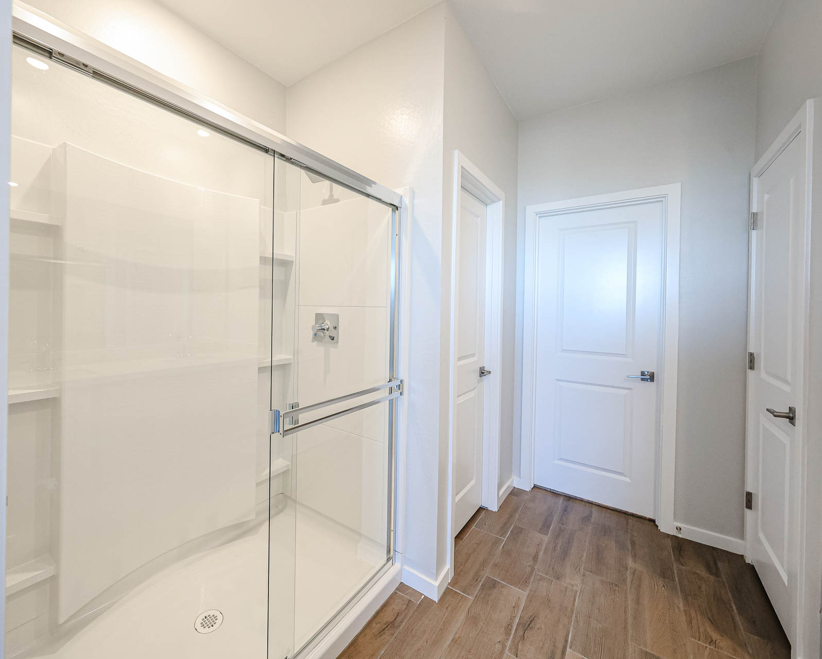 A bathroom with white doors.