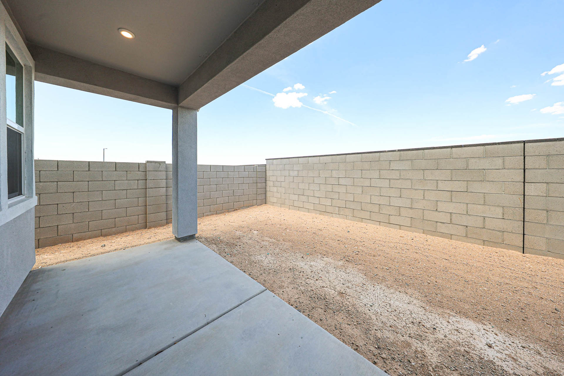 A concrete wall and a concrete walkway.