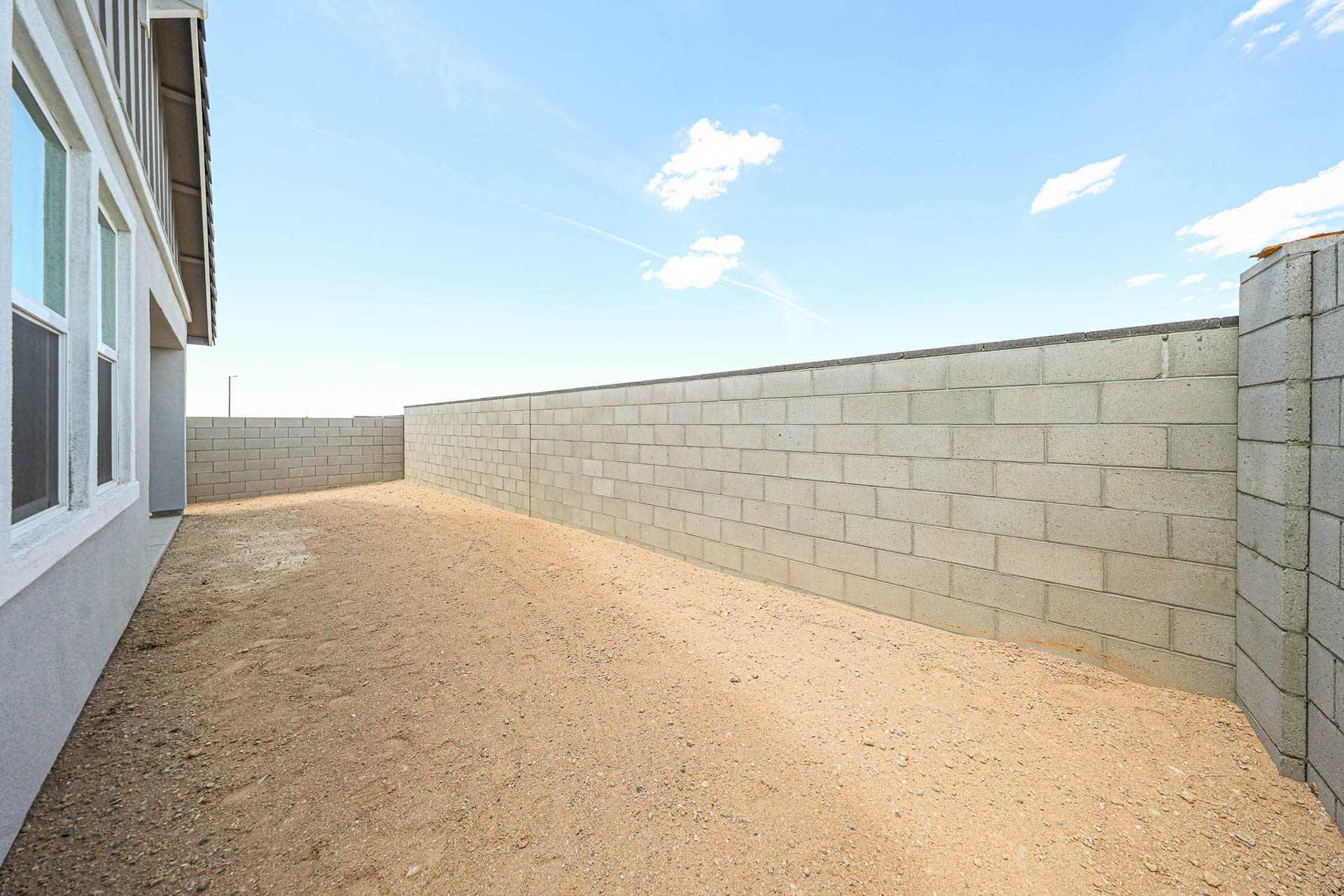 A dirt road between two buildings.