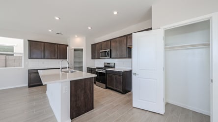 A kitchen with wooden cabinets.