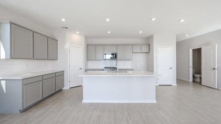 A large kitchen with white cabinets.