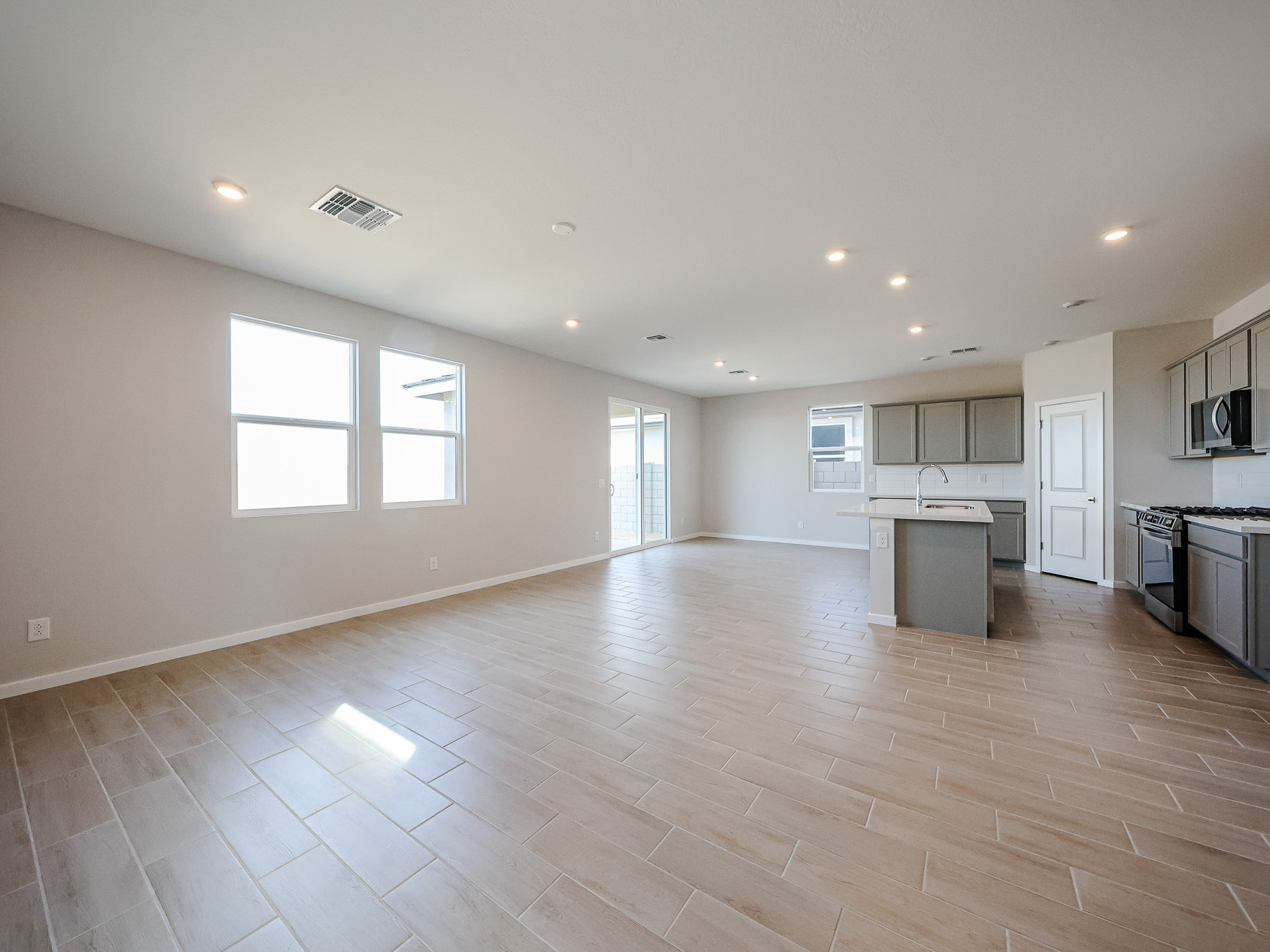 A large kitchen with wooden floors.