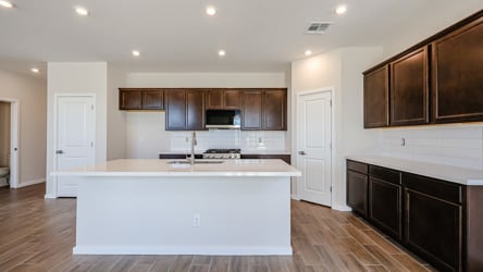 A kitchen with wooden cabinets.