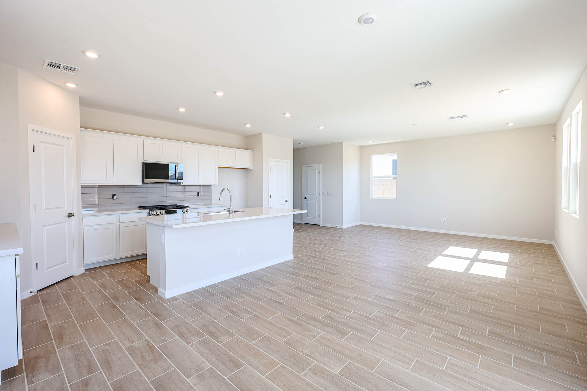 A large kitchen with white cabinets.