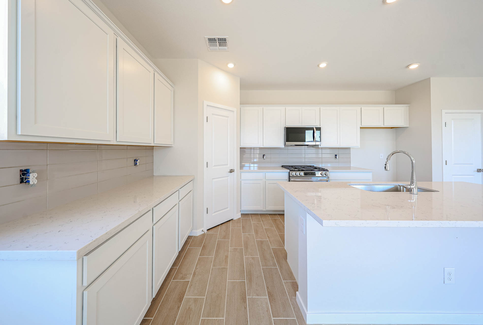 A kitchen with white cabinets.