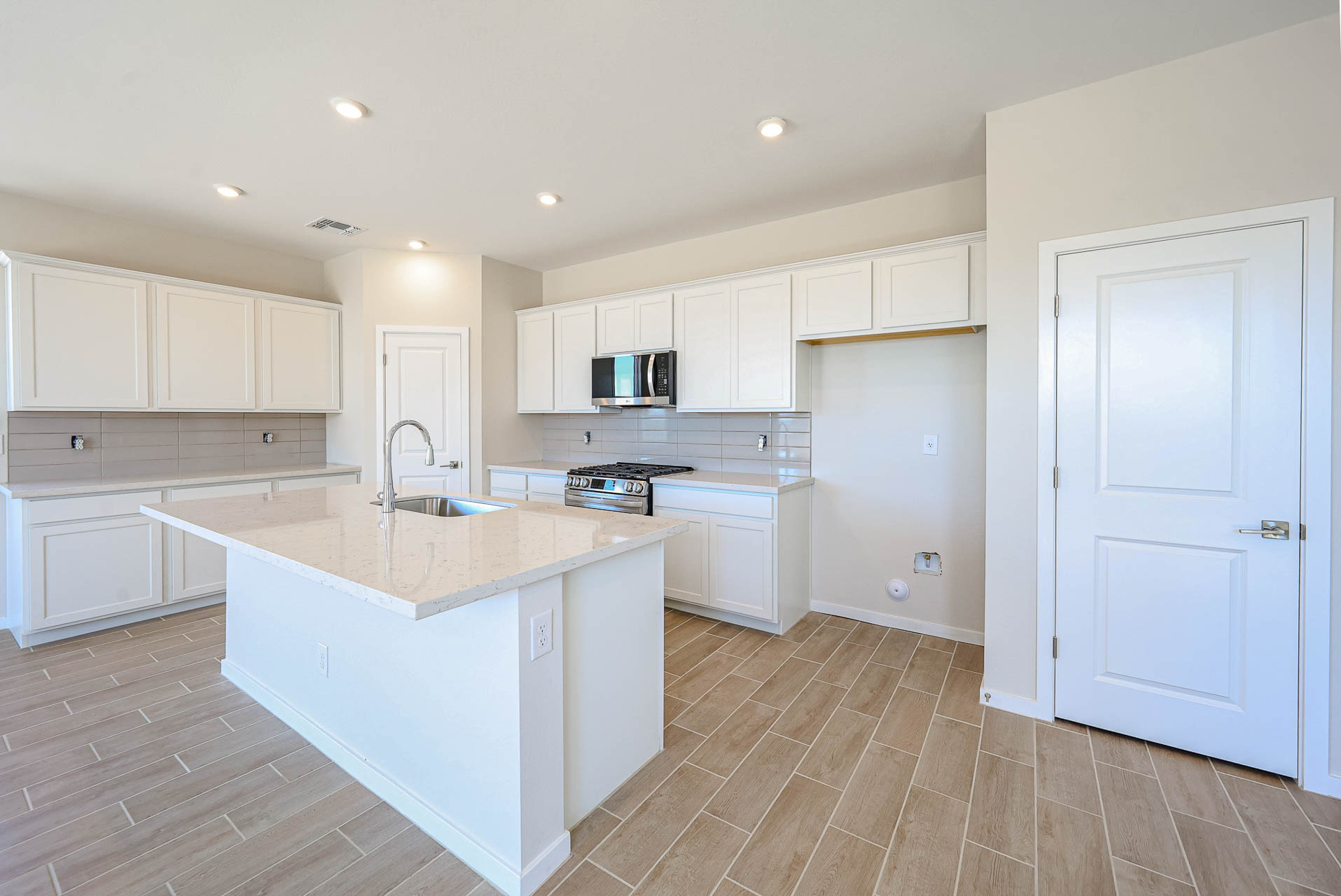 A kitchen with white cabinets.