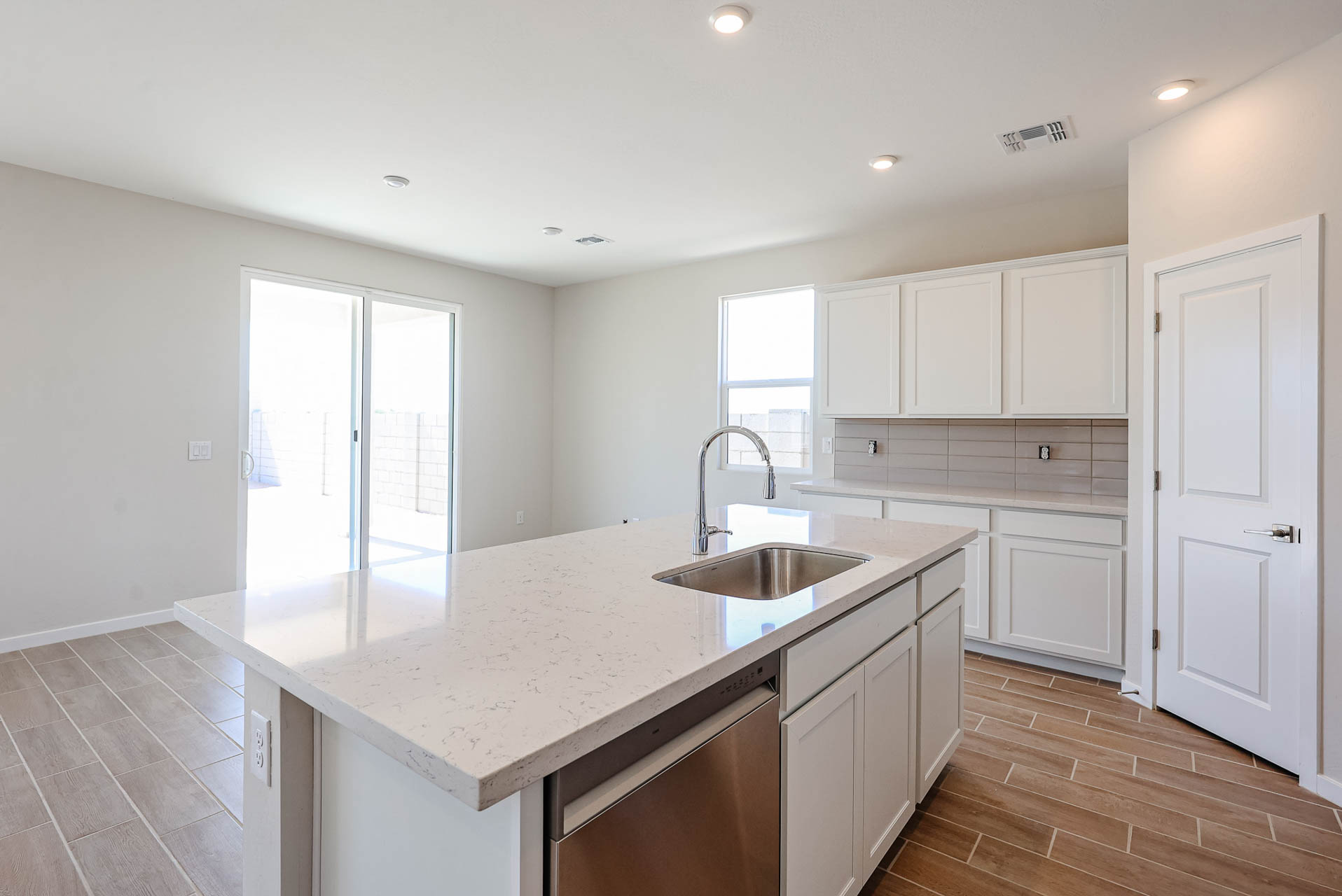 A kitchen with white cabinets.