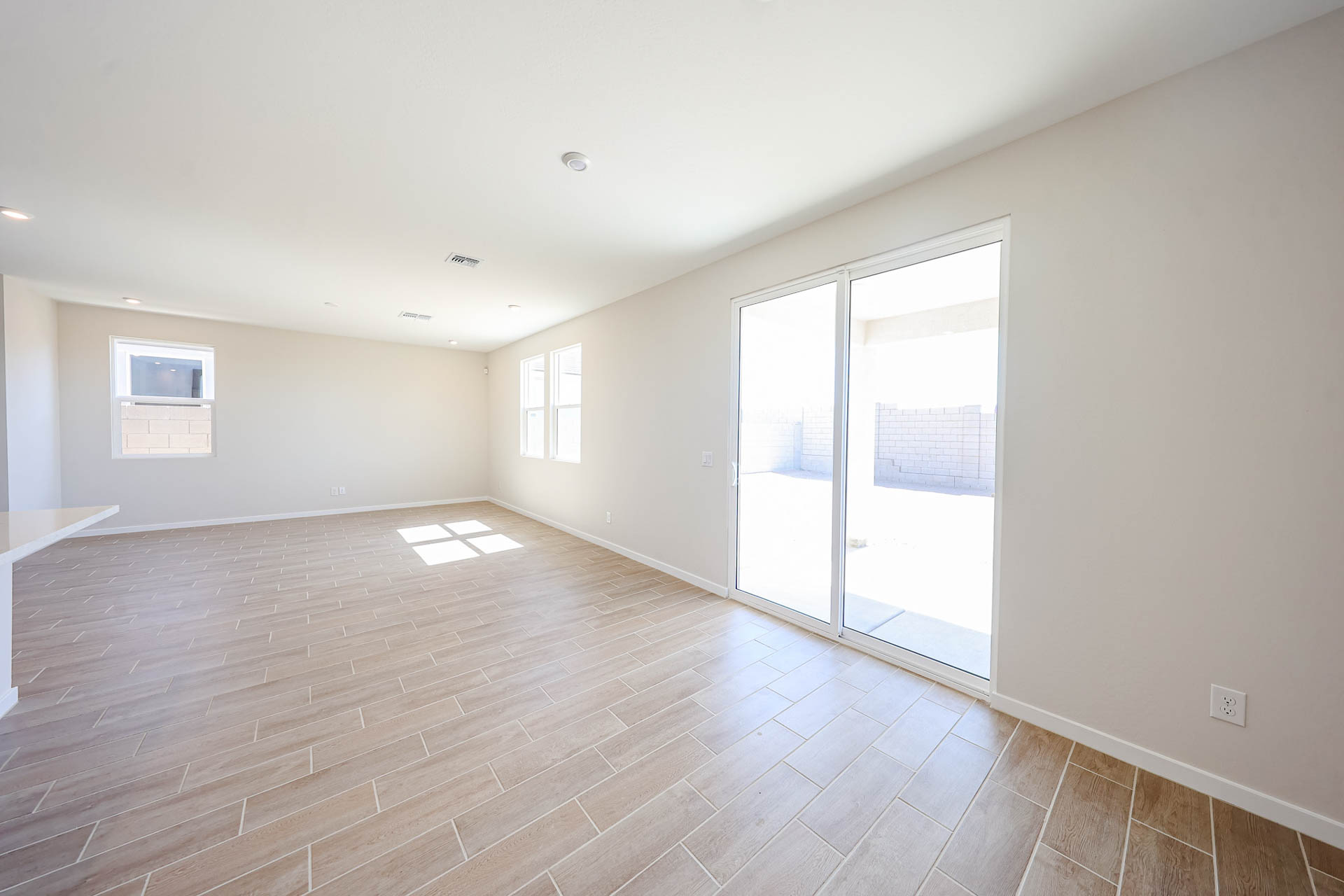 A room with a wood floor and a glass door.