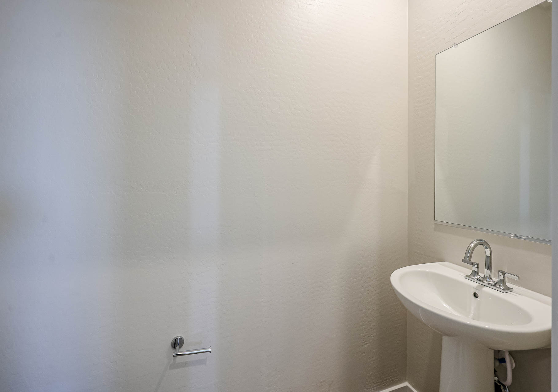 A bathroom with a mirror and sink.