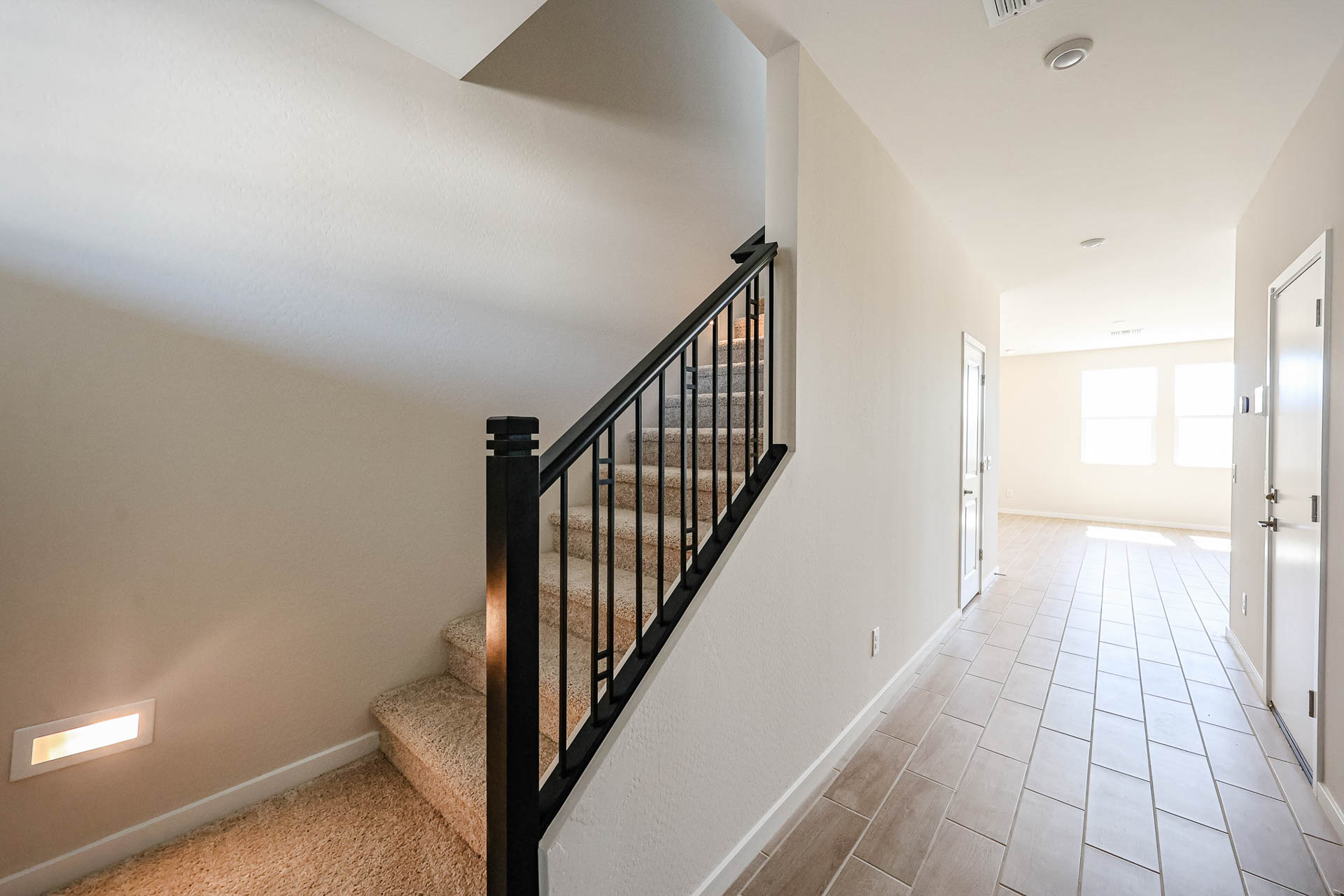 A hallway with a wood railing.