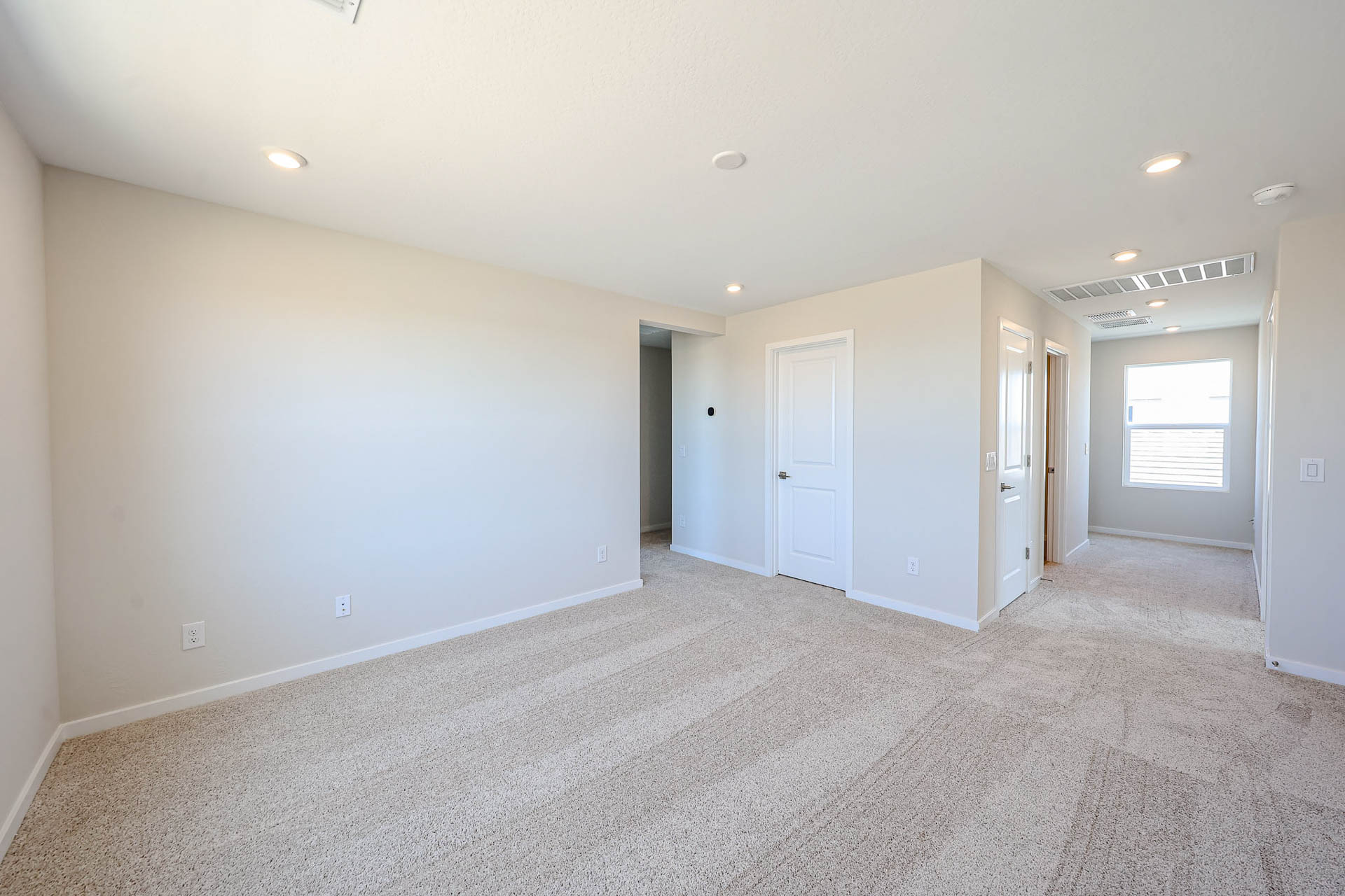 A room with white walls and doors.