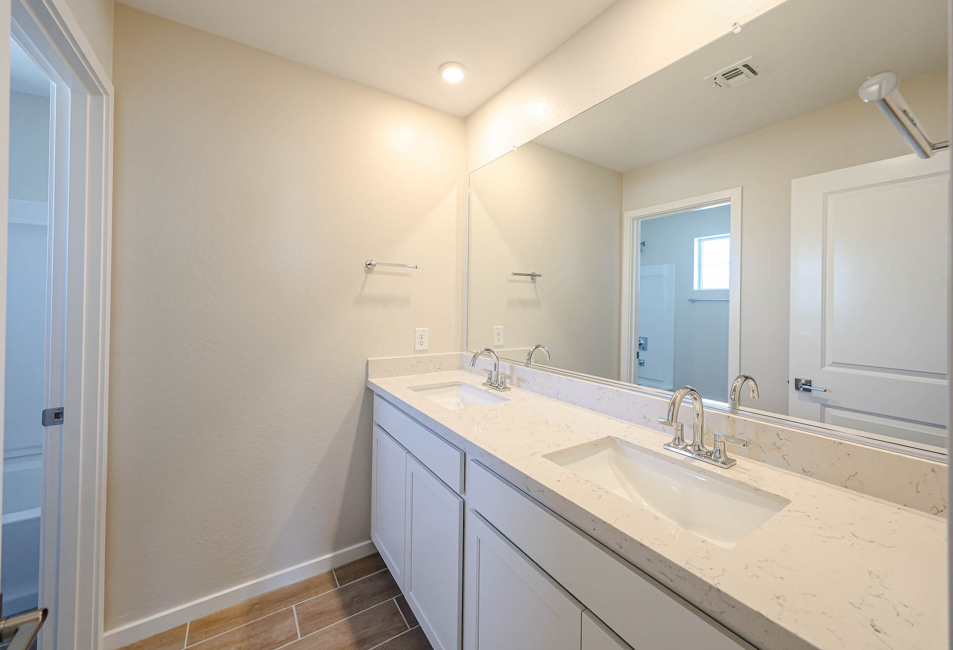 A bathroom with a large mirror.