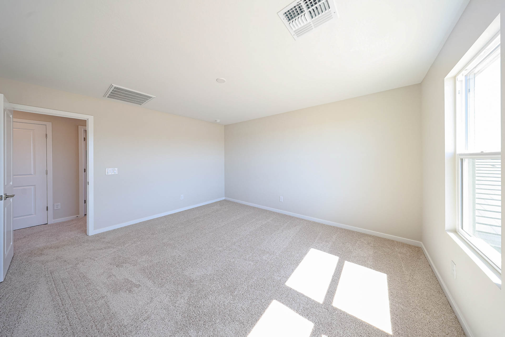 A room with white walls and a rug.