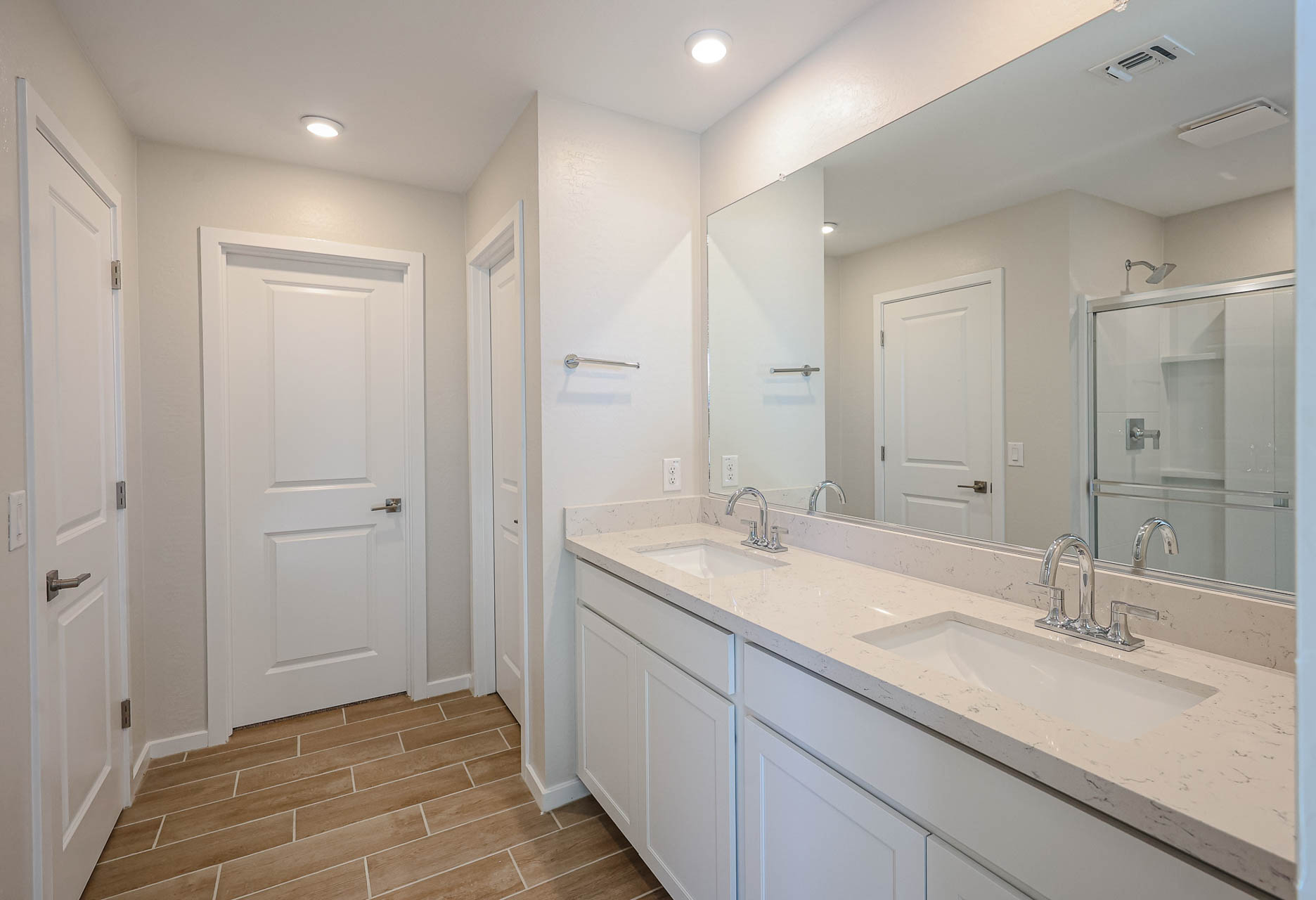 A bathroom with white cabinets.