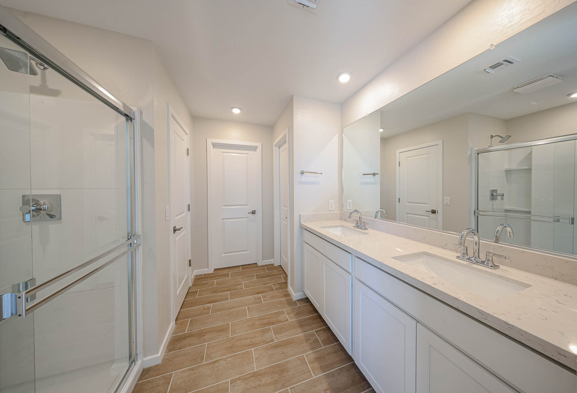 A bathroom with a large mirror.