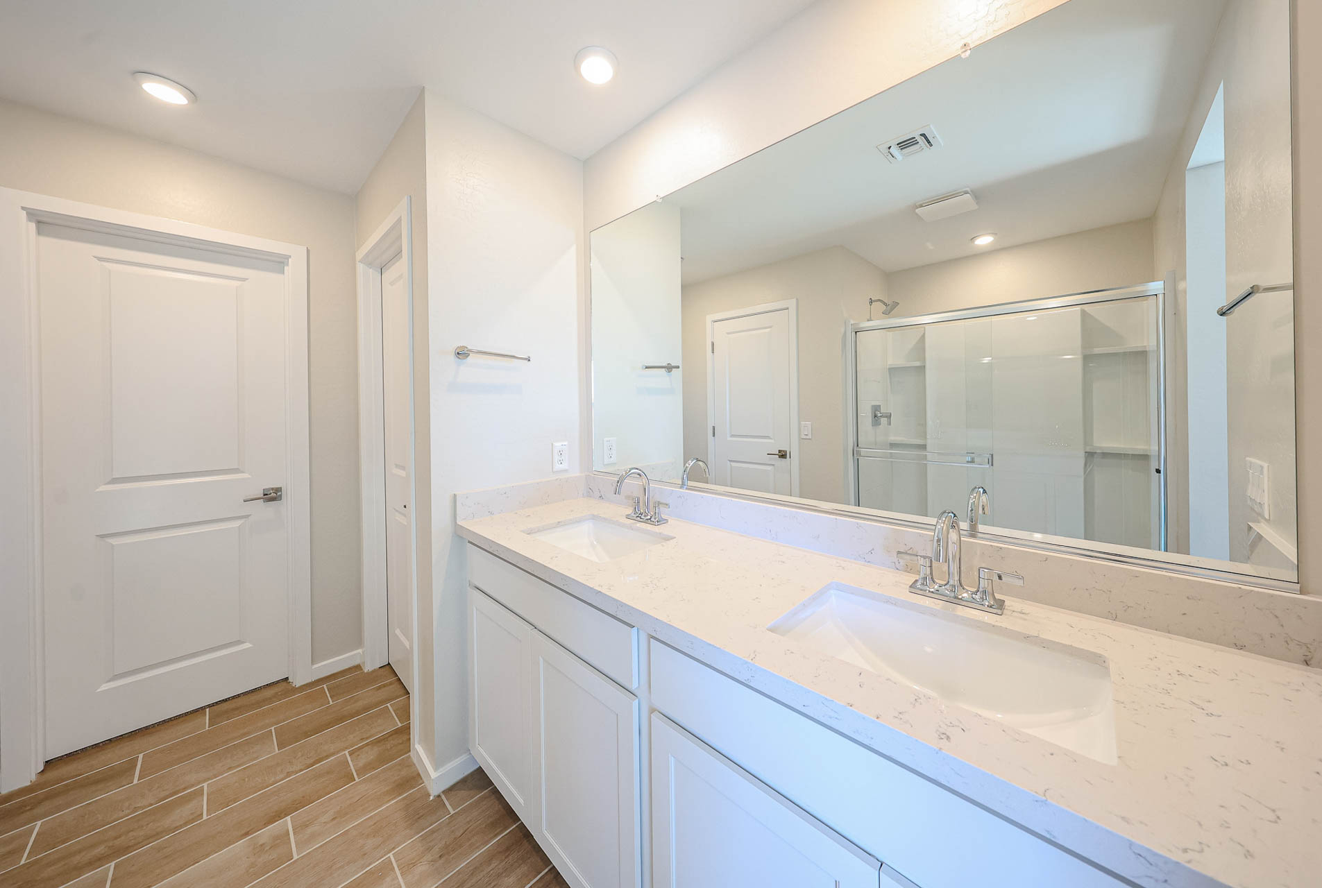 A bathroom with a large mirror.