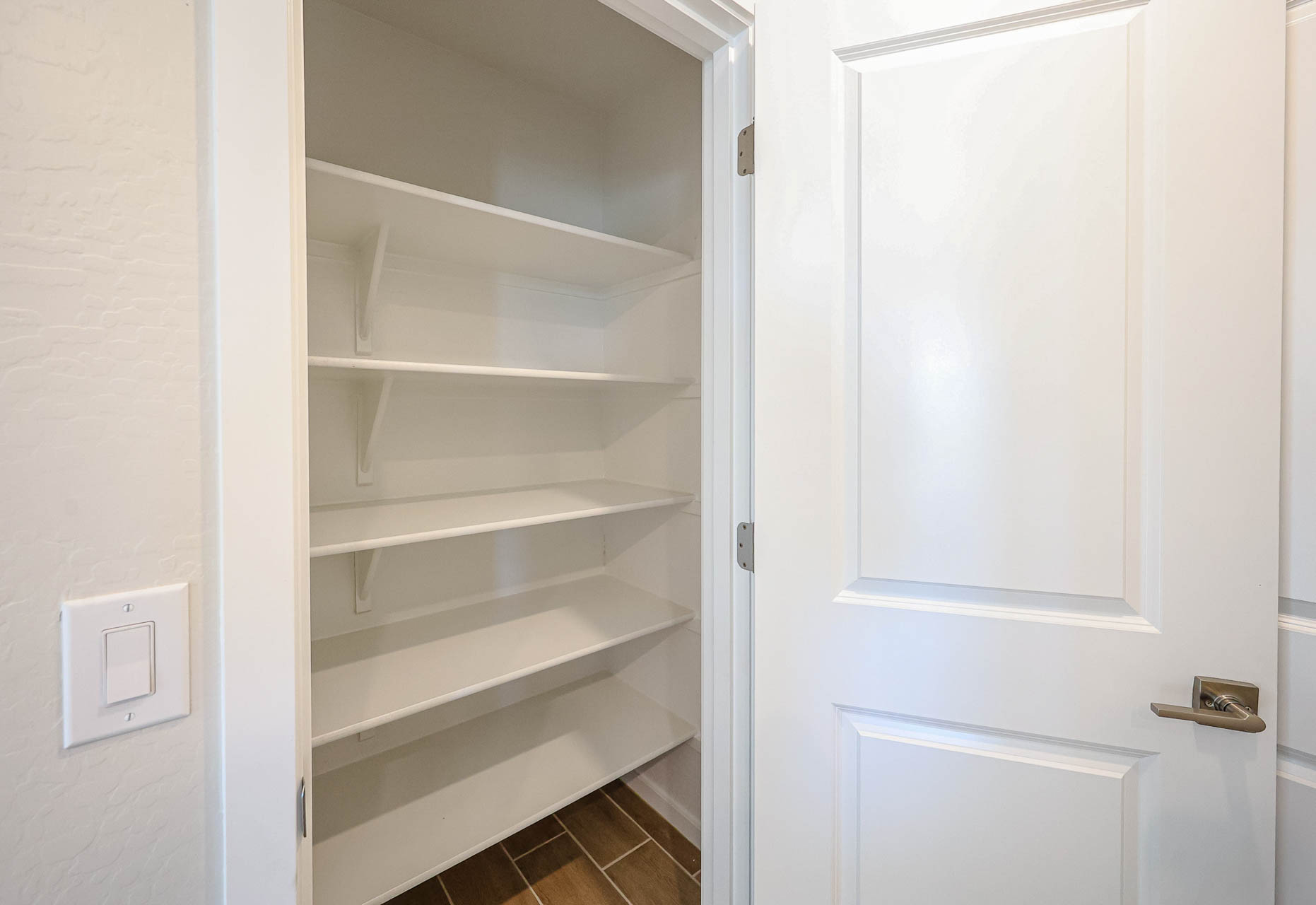 A white cabinet with white doors.