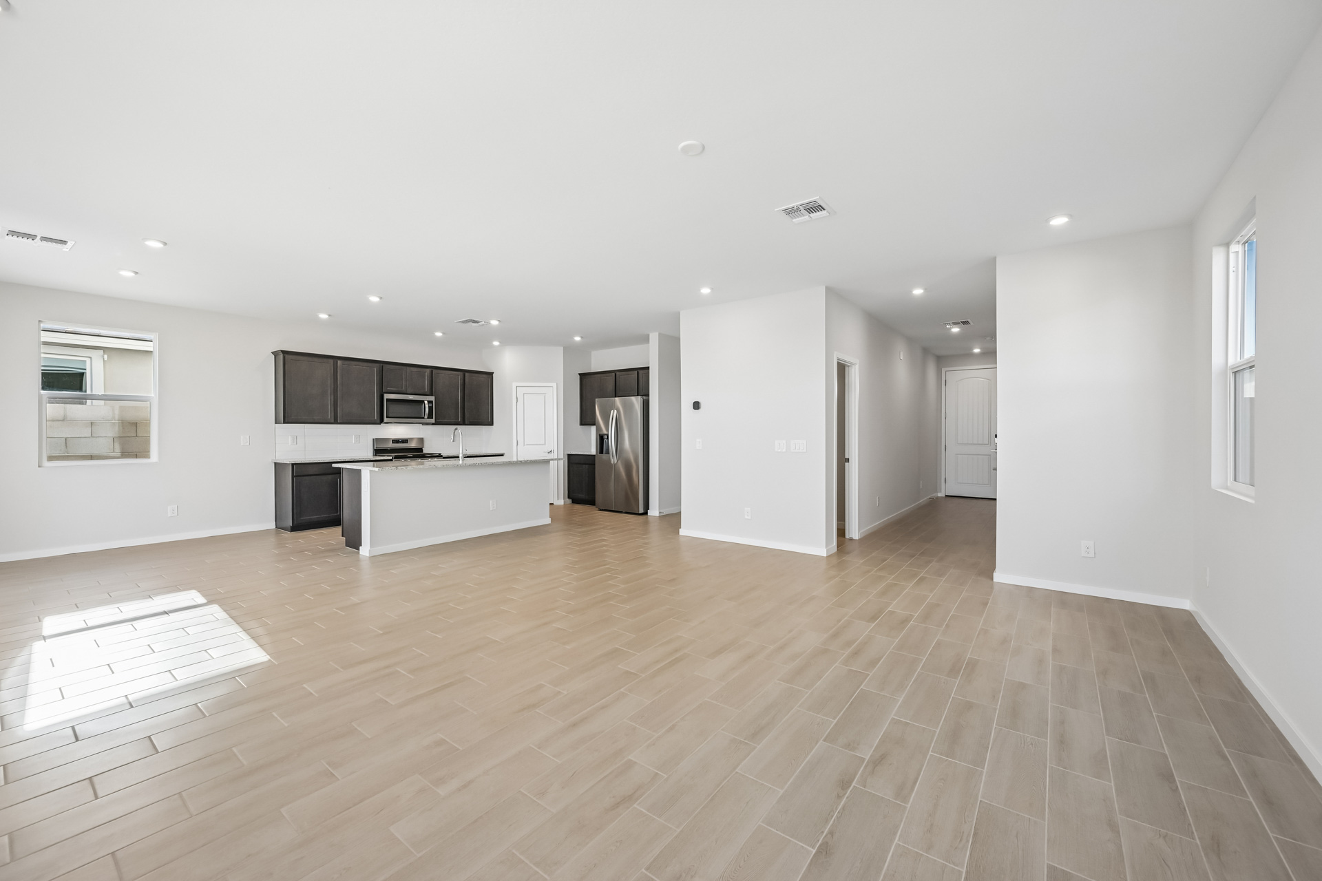 A large kitchen with white walls.
