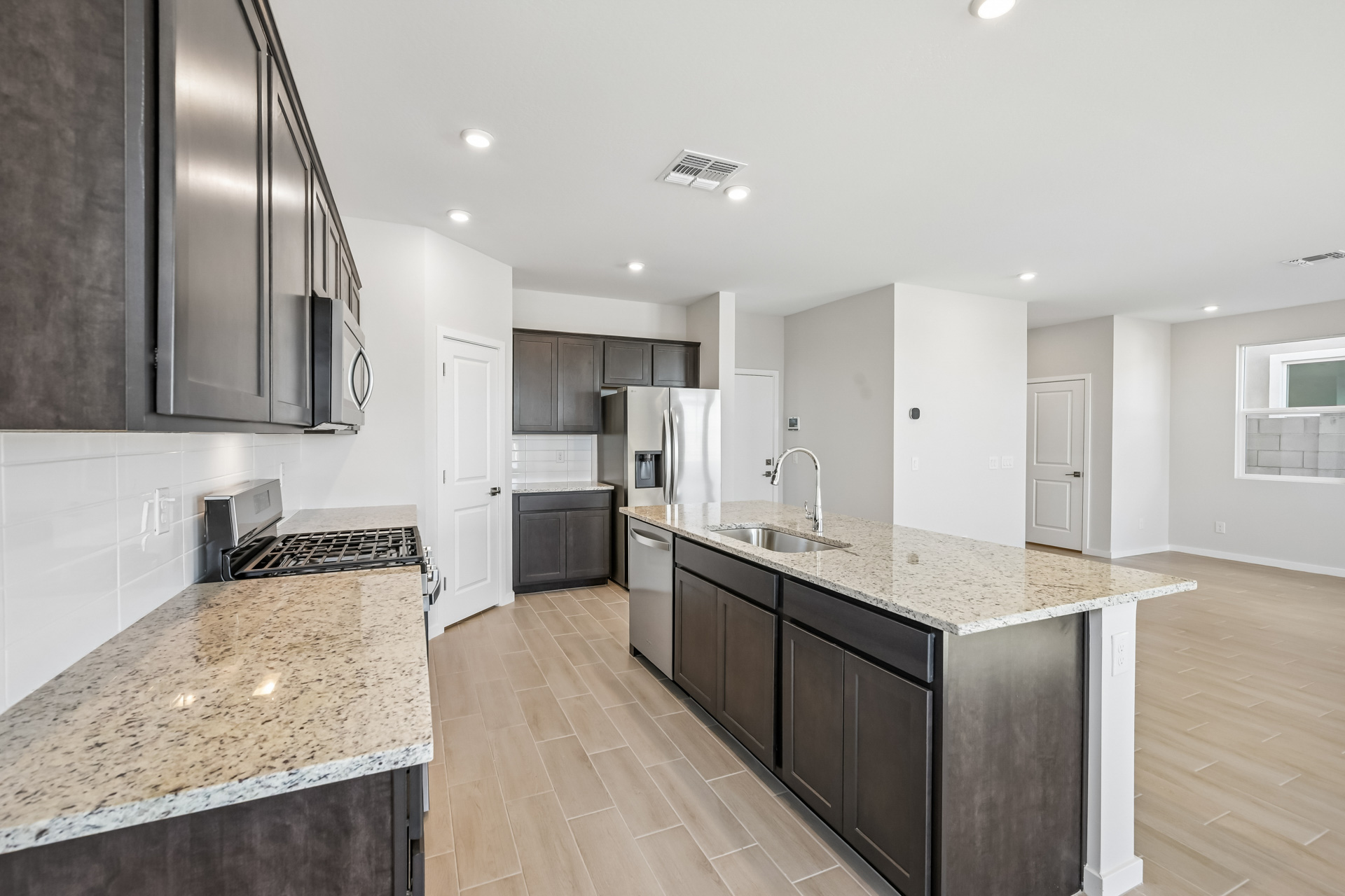 A kitchen with marble counters.