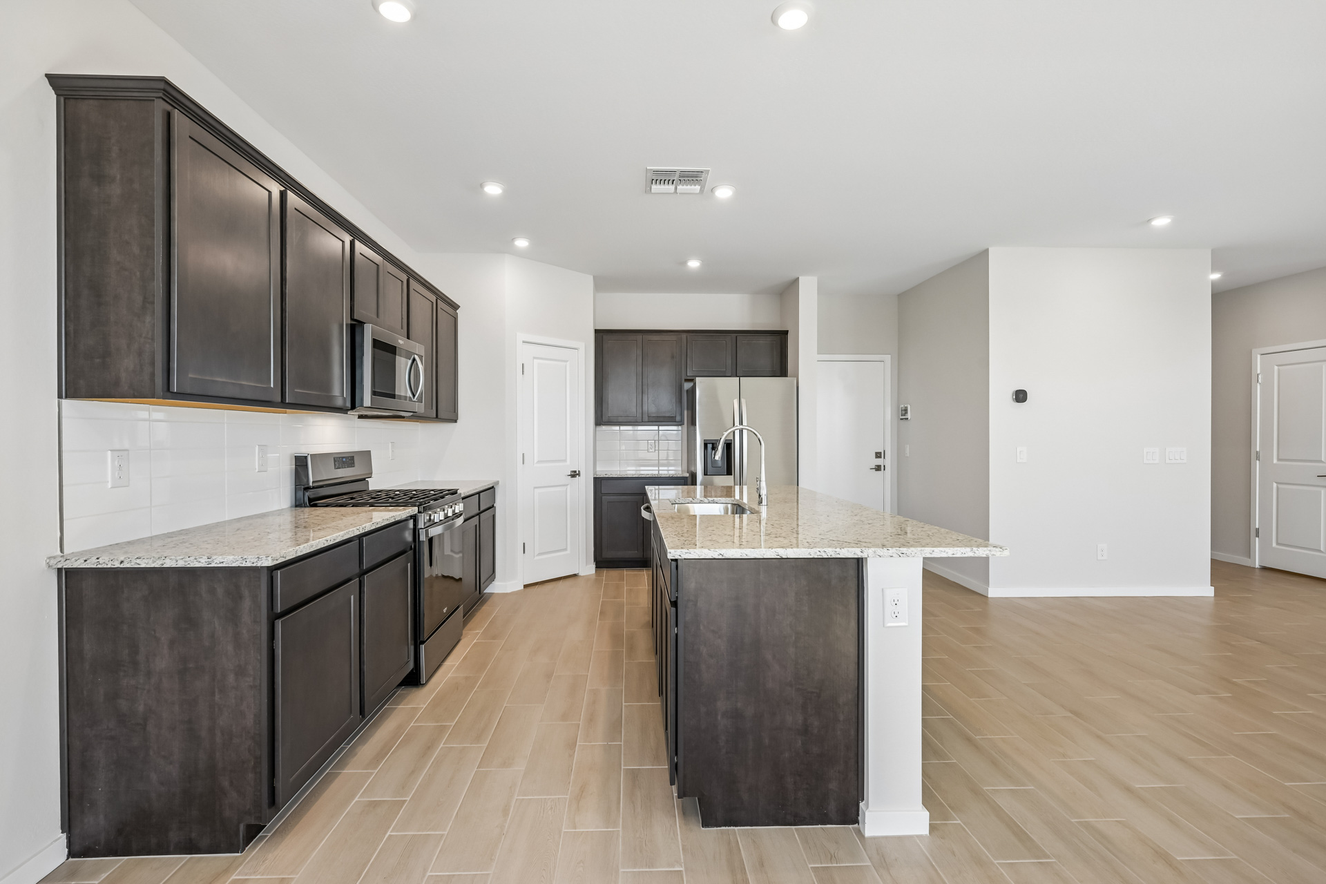 A kitchen with black cabinets.