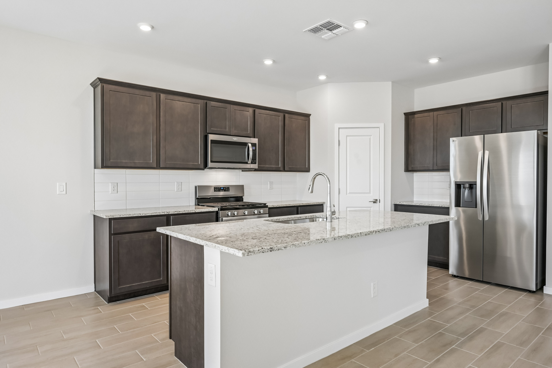 A kitchen with black cabinets.