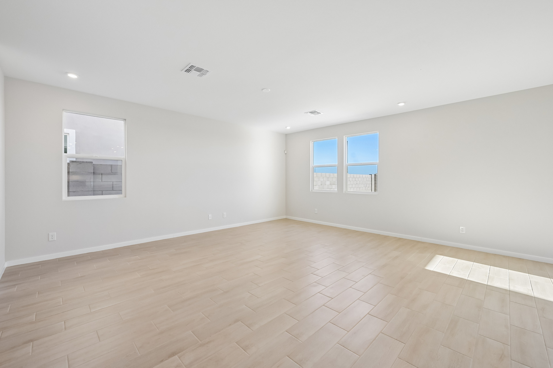 A room with a wood floor and white walls.